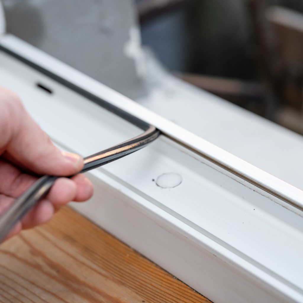 Professional master at repair and installation of windows, changes rubber seal gasket in pvc windows.